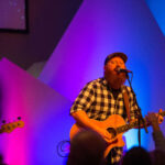 Jimmy Atkins plays music at a youth event