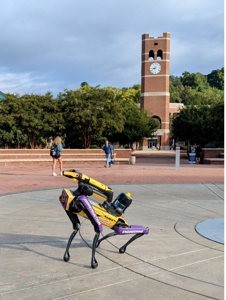 Spot the Catabot robot dog poses by the Alumni Tower at WCU