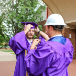 Twins help each oher prepare for cap and gown photos